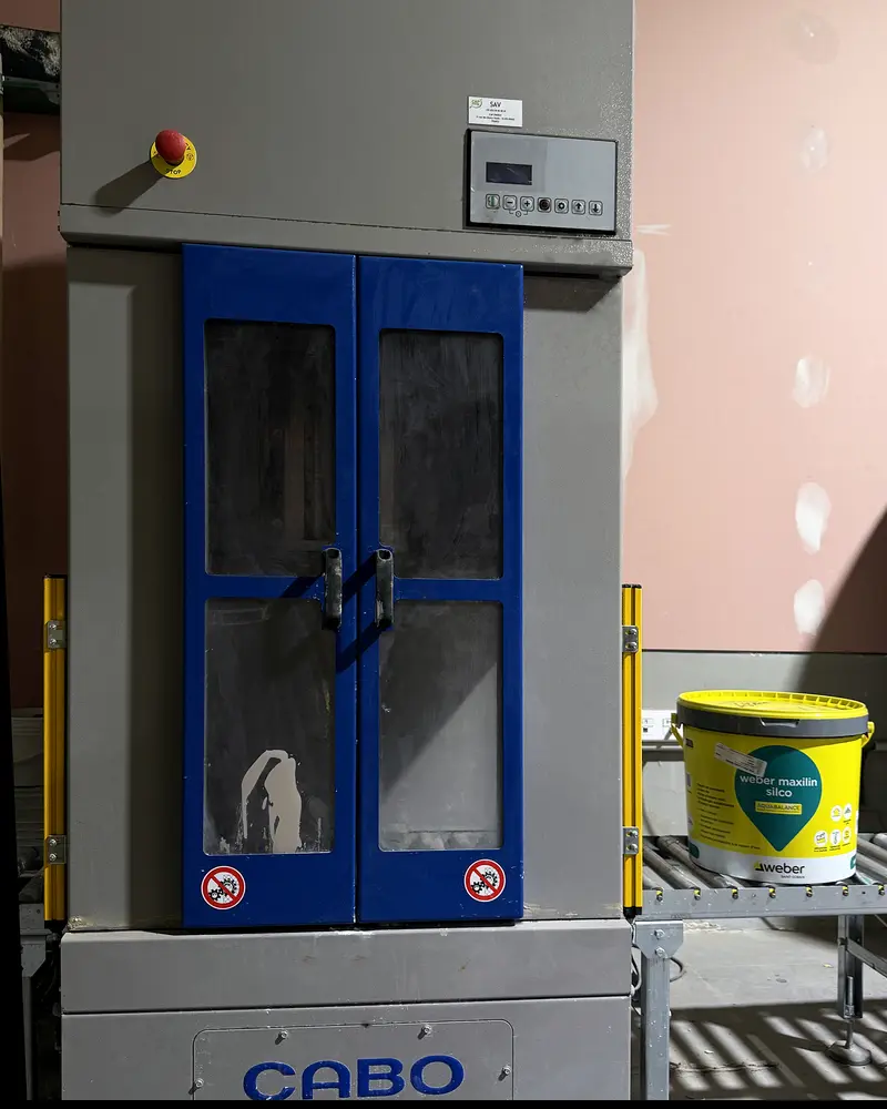 Machine à teinter pour RPE avec un seau sur le convoyeur, dans notre magasin de matériaux à Taissy près de Reims (Marne)